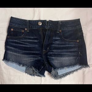 Women’s dark blue wash American Eagle denim shorts.